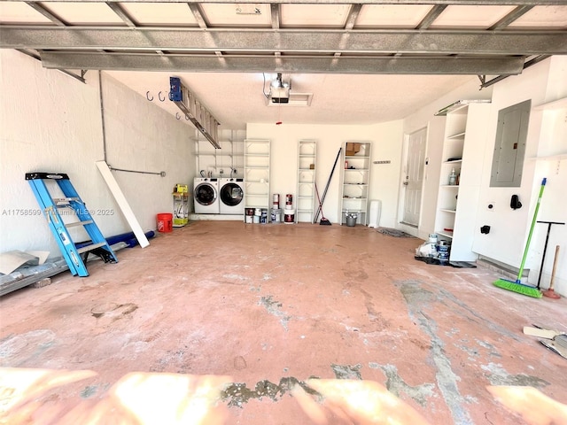 garage featuring a garage door opener, washer and dryer, and electric panel