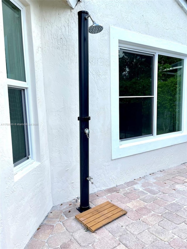 property entrance with stucco siding