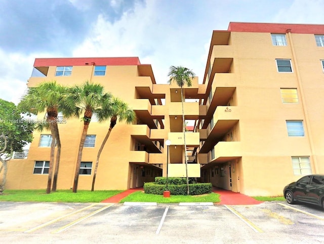 view of property featuring uncovered parking