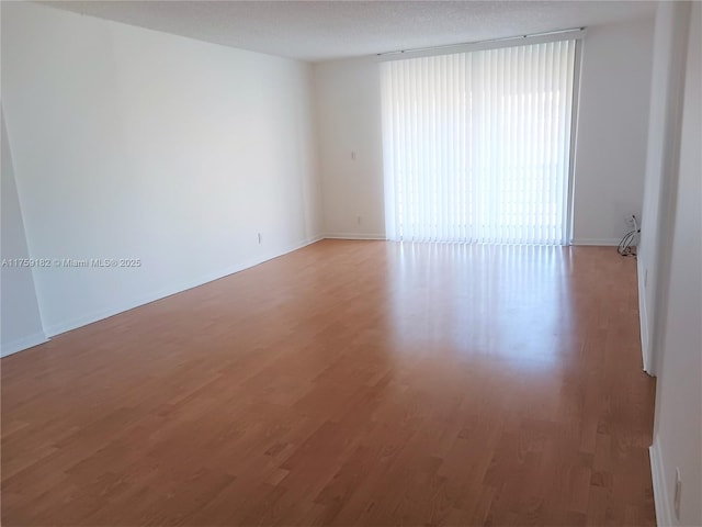 unfurnished room with light wood finished floors