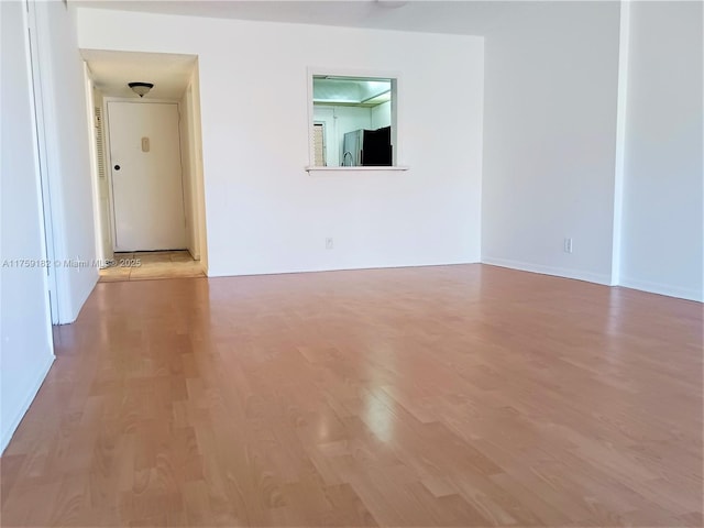 spare room featuring wood finished floors