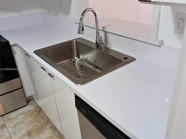 interior details with light countertops and a sink