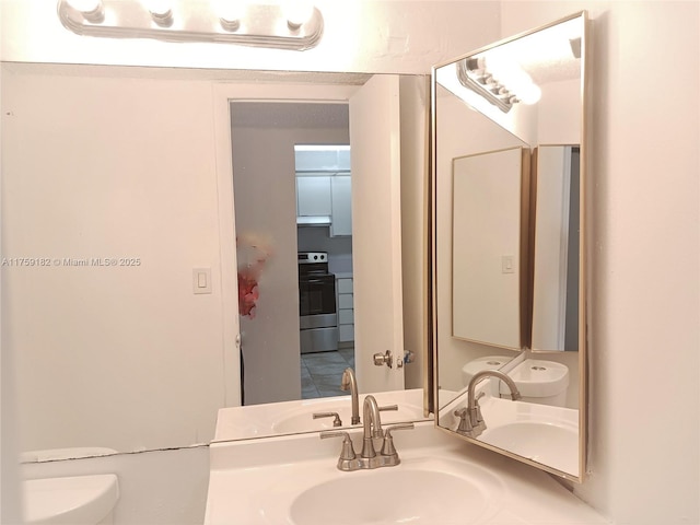 bathroom with toilet and a sink