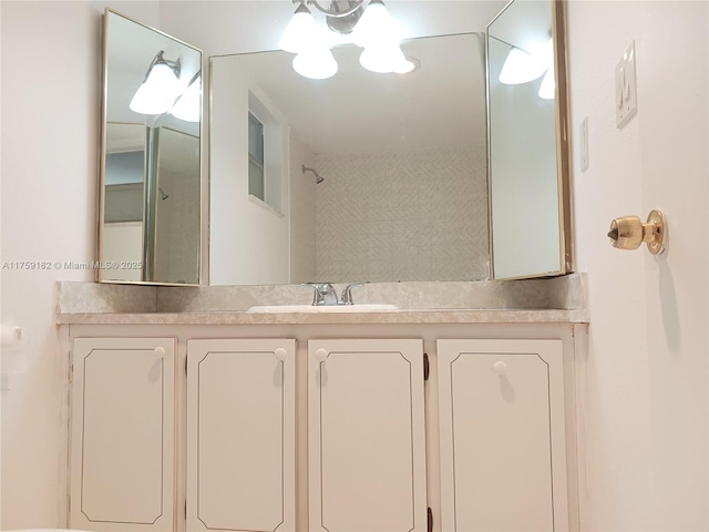 bathroom with walk in shower and vanity