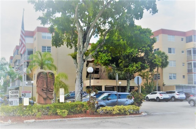 view of building exterior featuring uncovered parking