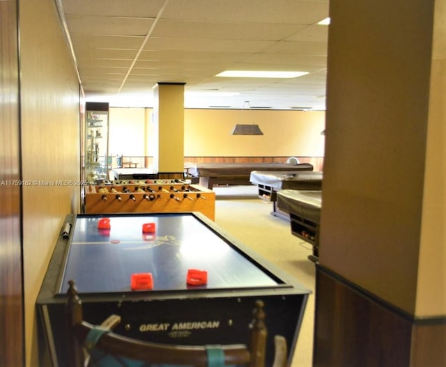 recreation room with a drop ceiling