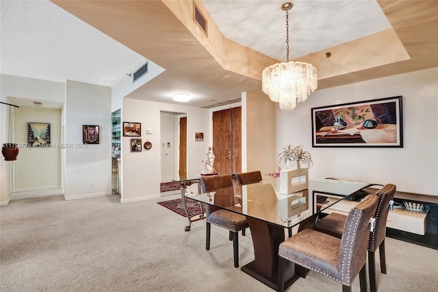 dining space featuring visible vents, baseboards, a chandelier, and carpet flooring