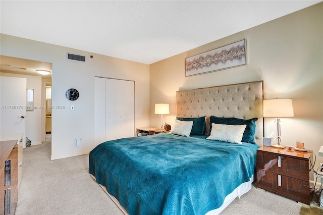 carpeted bedroom with a closet and visible vents