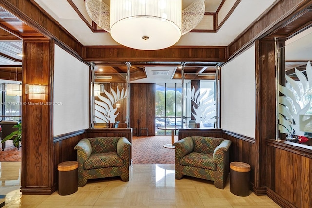 sitting room featuring wood walls and wainscoting