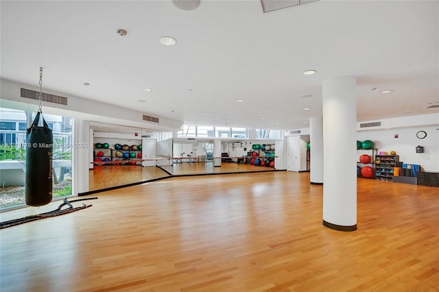 workout area with light wood-style flooring, recessed lighting, and visible vents