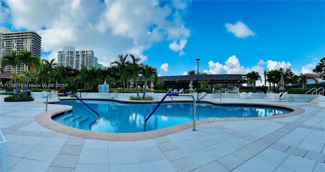 community pool featuring a view of city and a patio area