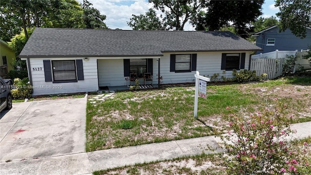 5127 Glasgow Ave, Orlando, FL 32819 - view of front of home featuring fence, a front lawn, covered porch, and roof with shingles
