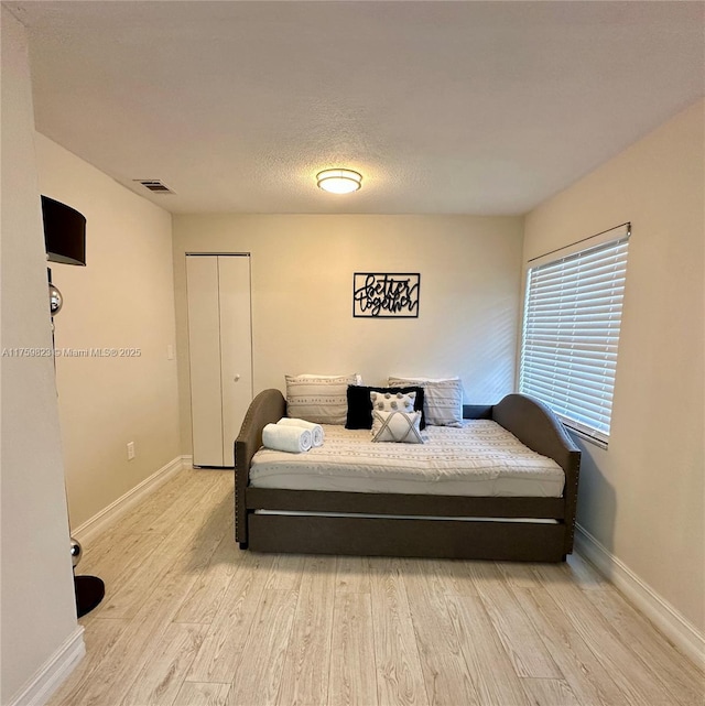 5127 Glasgow Ave, Orlando, FL 32819 - bedroom with a closet, light wood finished floors, baseboards, and visible vents
