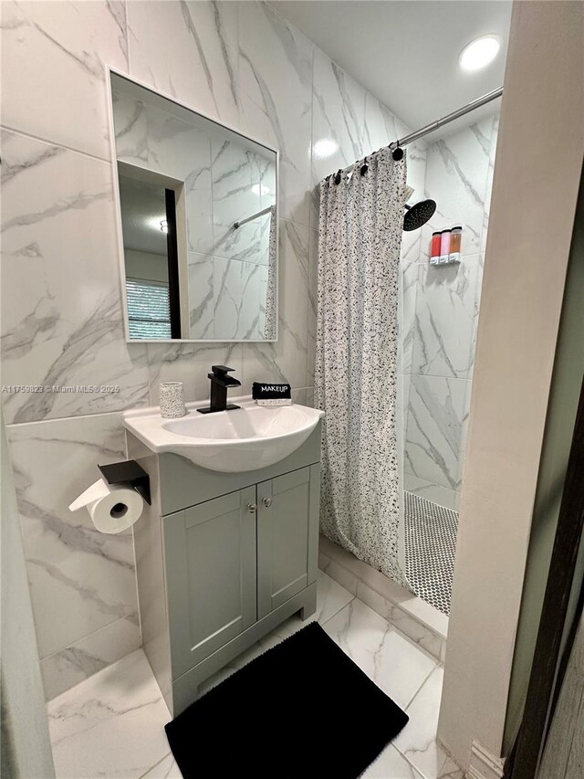 5127 Glasgow Ave, Orlando, FL 32819 - full bathroom featuring tile walls, marble finish floor, vanity, and a shower with curtain