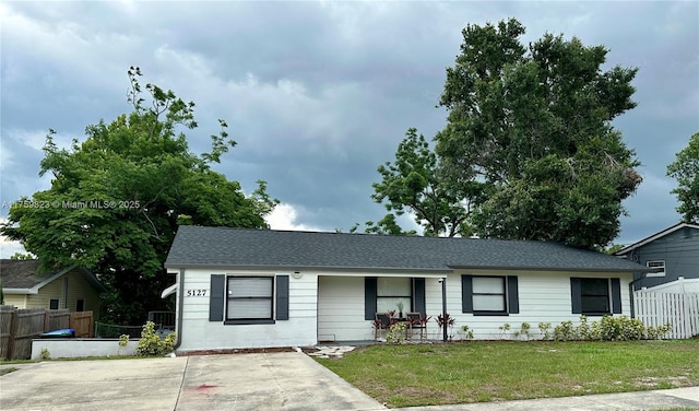 5127 Glasgow Ave, Orlando, FL 32819 - single story home featuring fence, a shingled roof, and a front yard