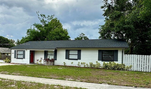 5127 Glasgow Ave, Orlando, FL 32819 - single story home featuring a front lawn, fence, and a shingled roof