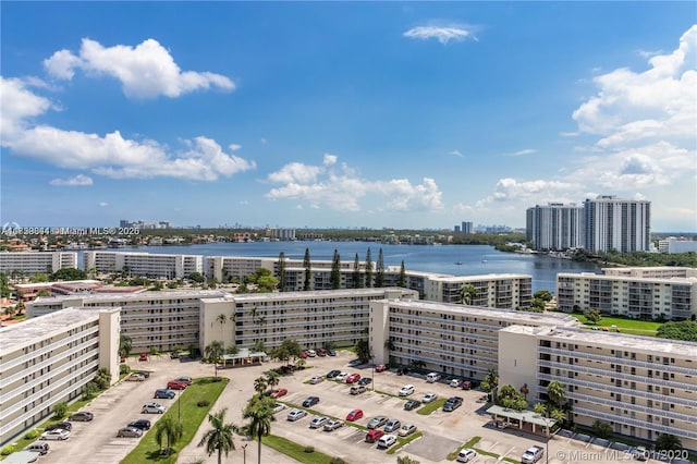 birds eye view of property with a city view and a water view