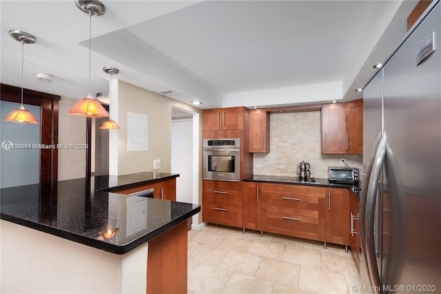 kitchen with a toaster, decorative backsplash, appliances with stainless steel finishes, and brown cabinetry