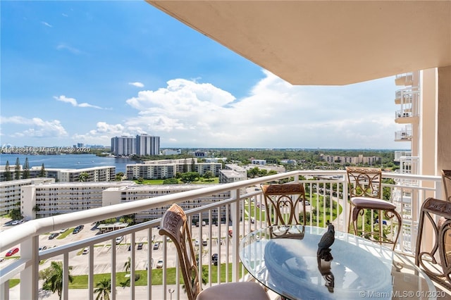 balcony featuring a city view and a water view