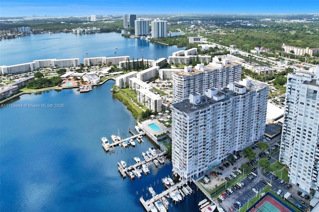 drone / aerial view featuring a view of city and a water view