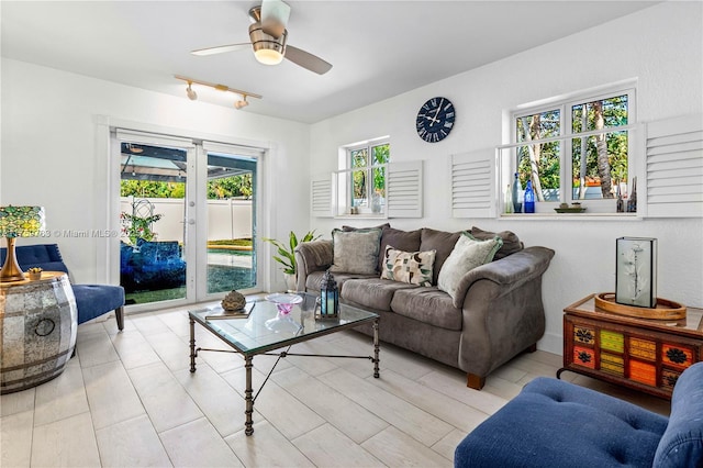 living room with track lighting, french doors, and a ceiling fan