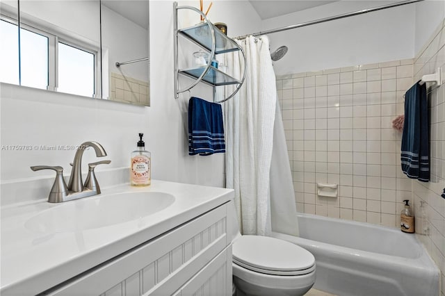 full bath featuring shower / bath combo with shower curtain, toilet, and vanity