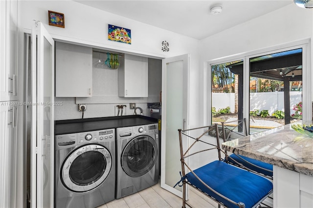 washroom with light wood-type flooring and washing machine and clothes dryer