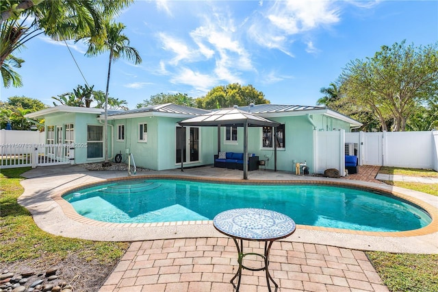 exterior space with a fenced in pool, french doors, a fenced backyard, a patio area, and a gate