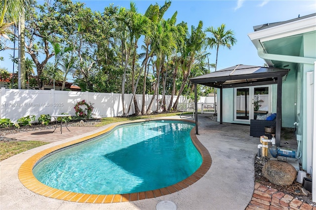 view of swimming pool featuring a gazebo, a patio area, a fenced in pool, and a fenced backyard