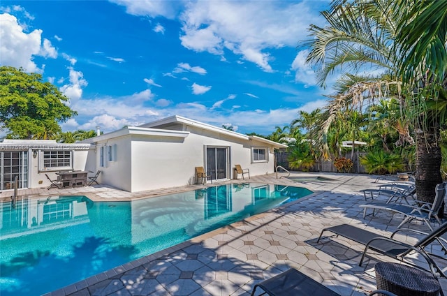 view of swimming pool with a fenced in pool, a patio, and fence