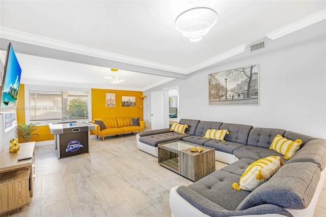 living room featuring visible vents, light wood-type flooring, and ornamental molding