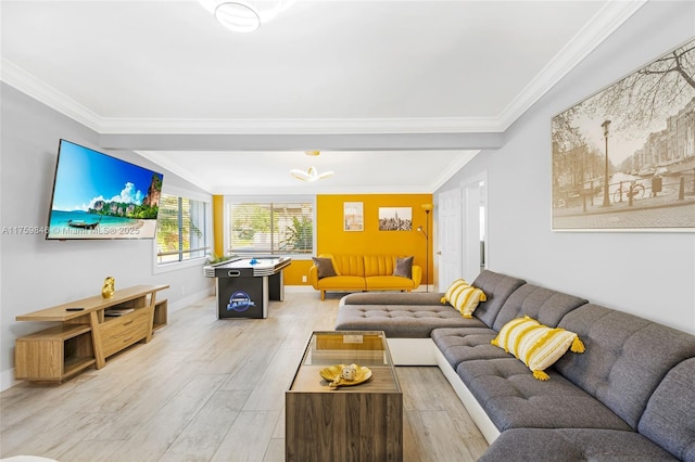 living area featuring crown molding, light wood-style floors, and baseboards
