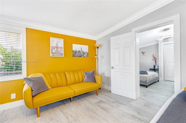 sitting room with wood finished floors, baseboards, and ornamental molding
