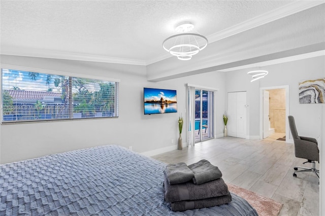 bedroom featuring a textured ceiling, light wood-type flooring, baseboards, and ornamental molding