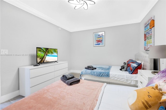 bedroom with baseboards and ornamental molding