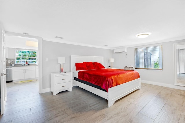 bedroom featuring visible vents, an AC wall unit, ornamental molding, light wood finished floors, and baseboards