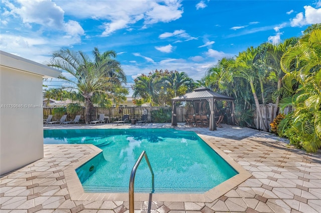 view of swimming pool featuring a gazebo, a fenced in pool, fence private yard, and a patio