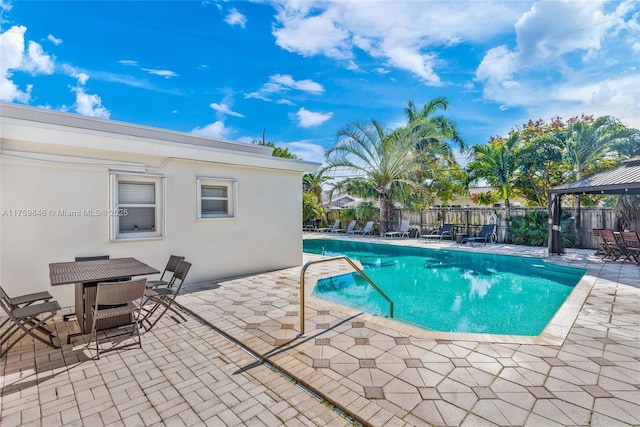 view of pool featuring a fenced in pool, fence, outdoor dining space, and a patio area