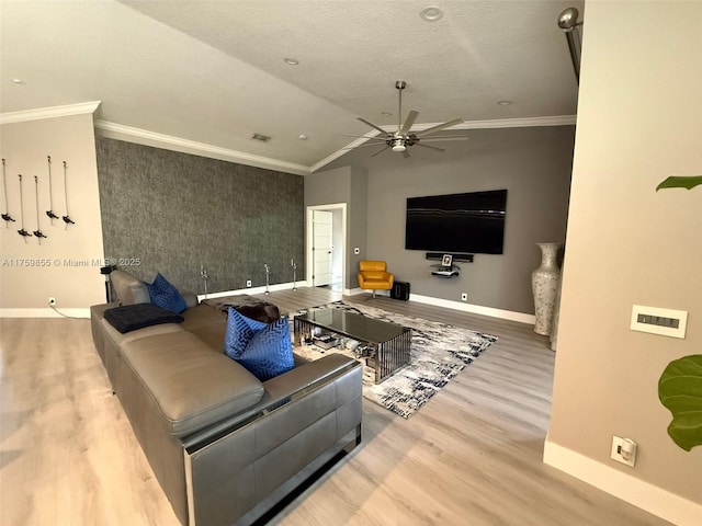 living room featuring lofted ceiling, baseboards, crown molding, and wood finished floors