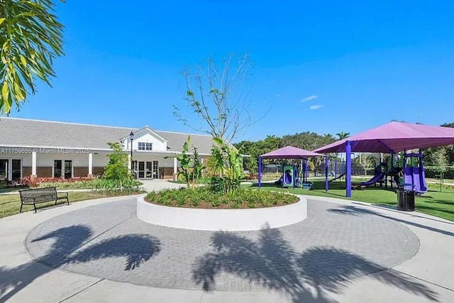 view of community featuring playground community and a yard