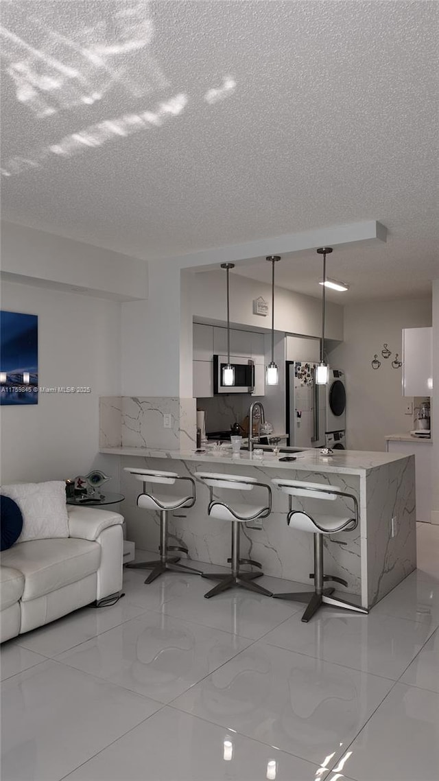 interior space with marble finish floor and a textured ceiling