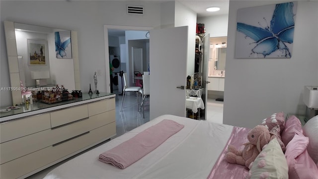 bedroom with visible vents and ensuite bathroom