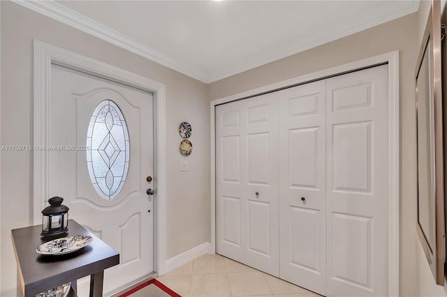 entryway featuring ornamental molding, light tile patterned flooring, and baseboards