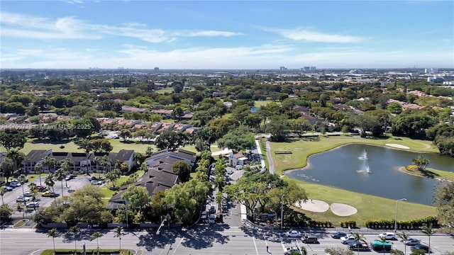 aerial view with golf course view and a water view