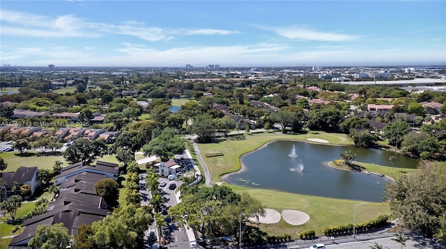 aerial view with golf course view and a water view