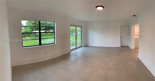 unfurnished room featuring visible vents and baseboards