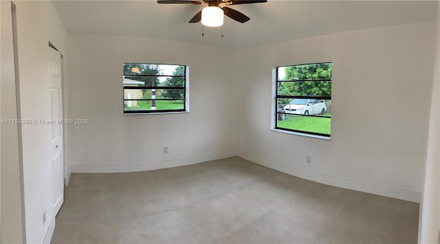 empty room featuring baseboards, a healthy amount of sunlight, and ceiling fan