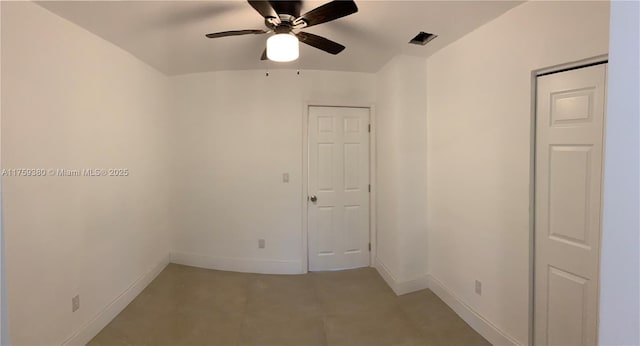 empty room featuring baseboards and a ceiling fan