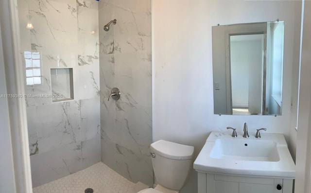 full bathroom featuring a marble finish shower, toilet, and vanity