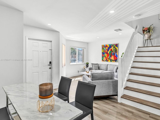 dining area featuring recessed lighting, visible vents, stairs, and light wood finished floors